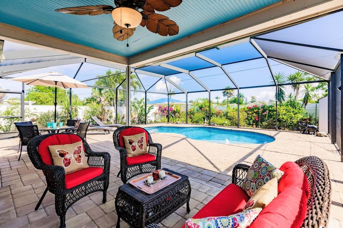 Your garden oasis awaits. Enjoy spending time with family and friends on this covered patio within a screened lanai. 